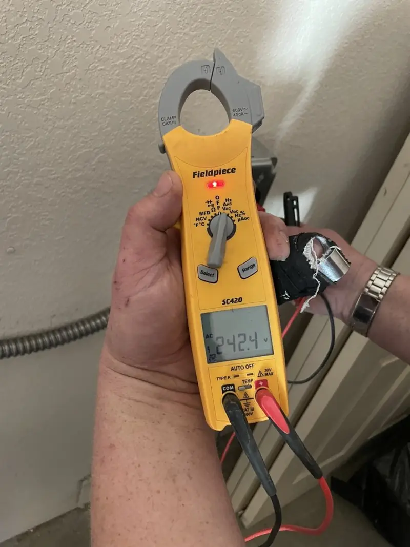 Voltage testing with clamp meter during Outlet Installation in Spencer